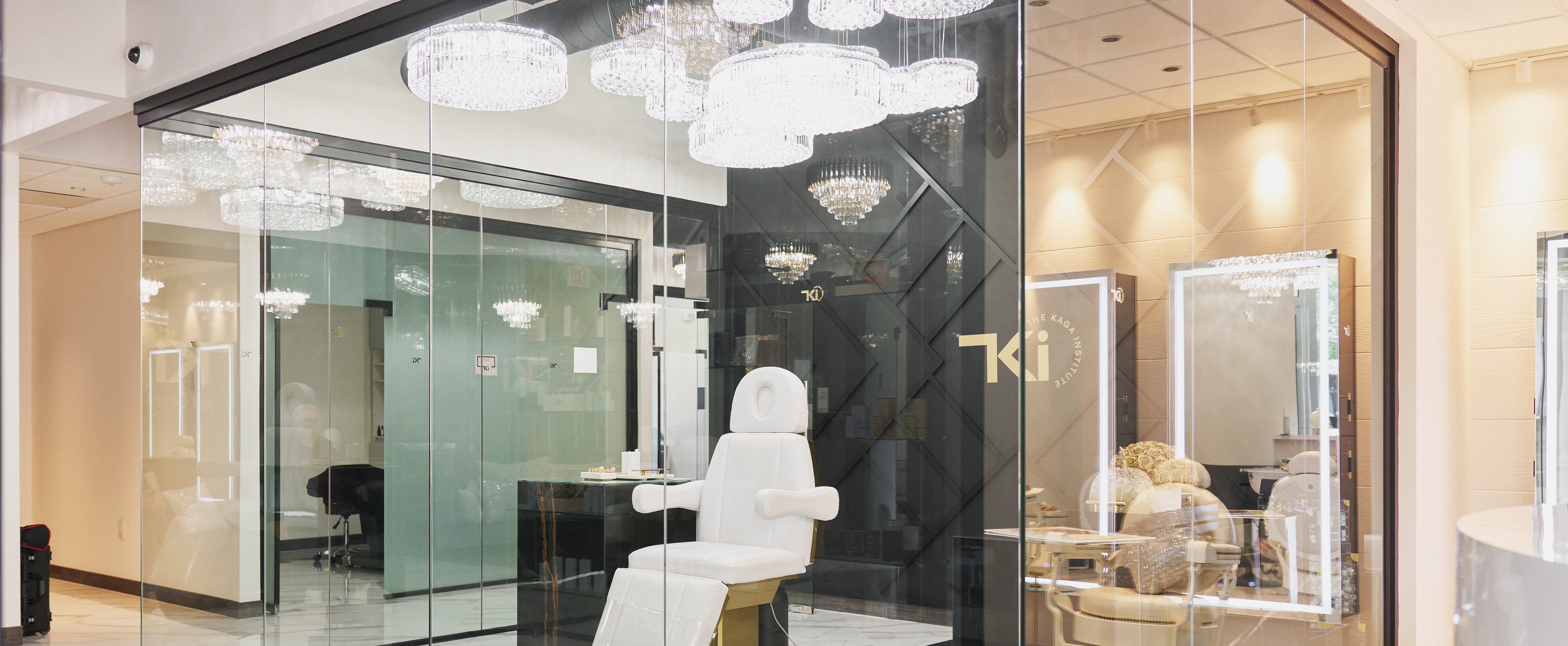 Treatment suite at The Kaga Institute, with glass walls and crystal chandeliers