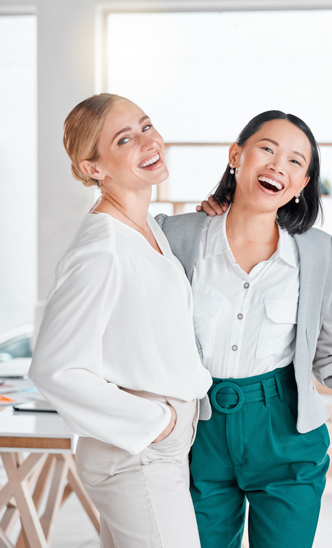 Photo of two smiling women with great skin