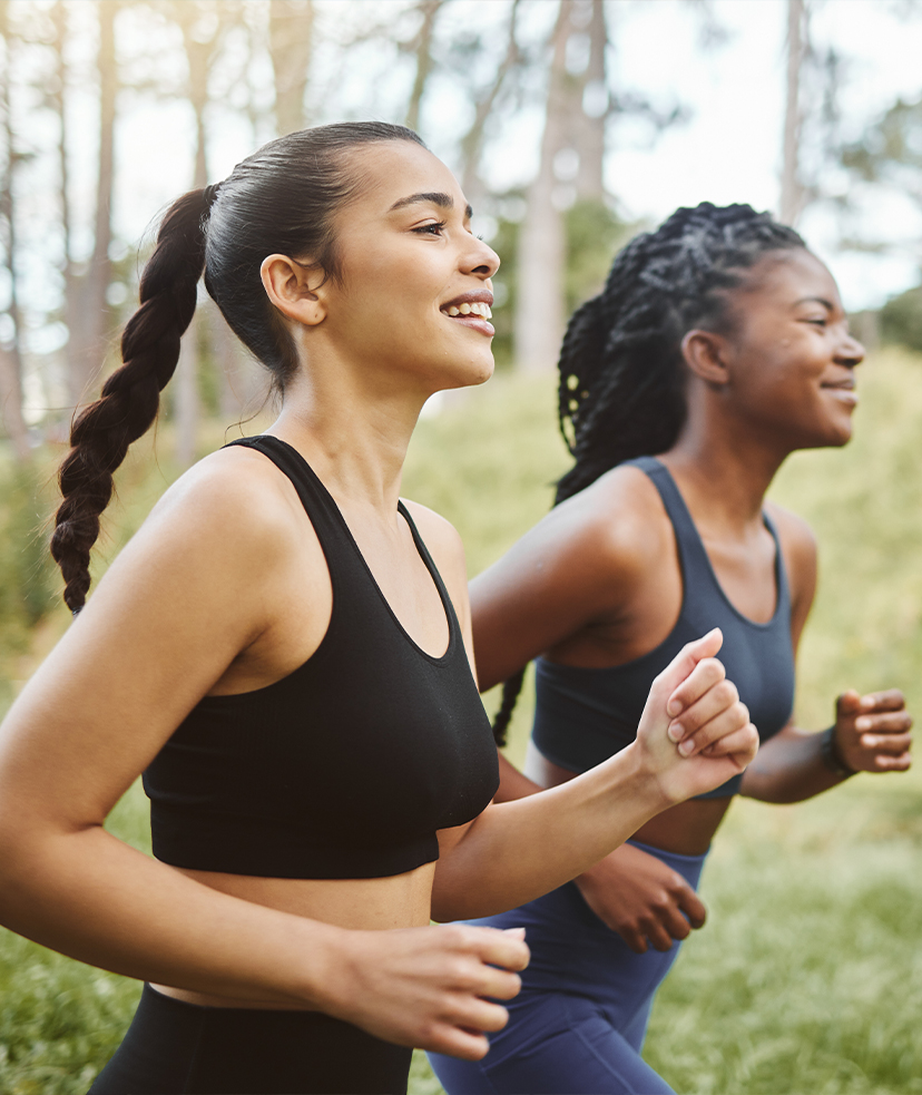 Photo of two women jogging in the woods