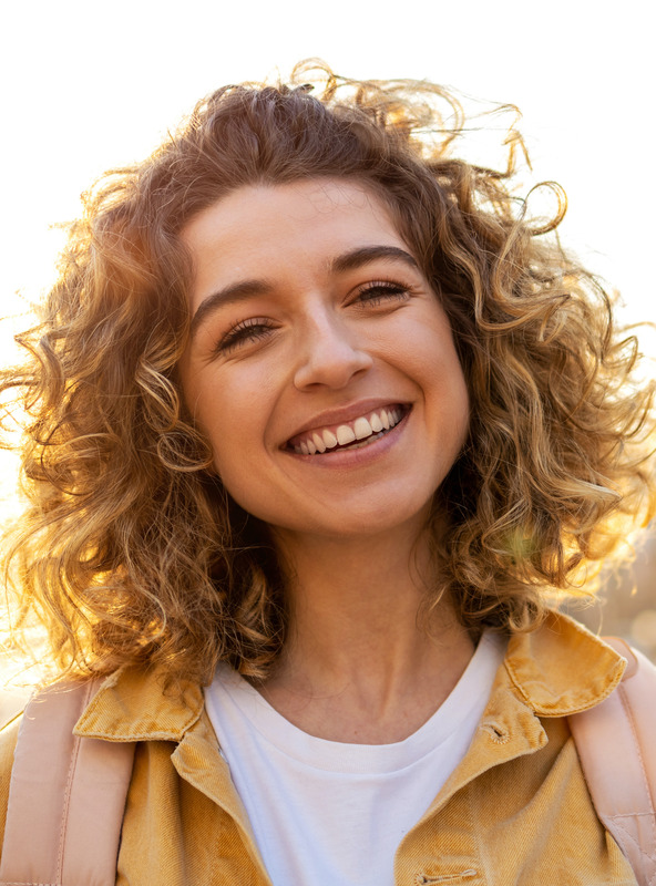 Photo of a blonde woman outside as the sun is starting to set